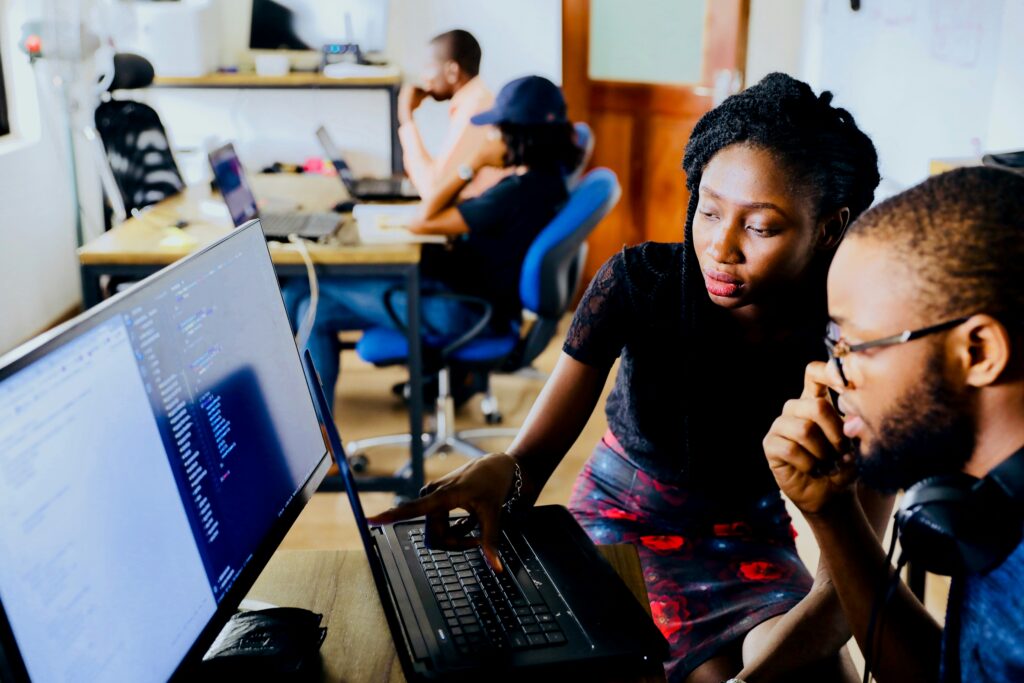 woman-and-man-sitting-in-front-of-monitor